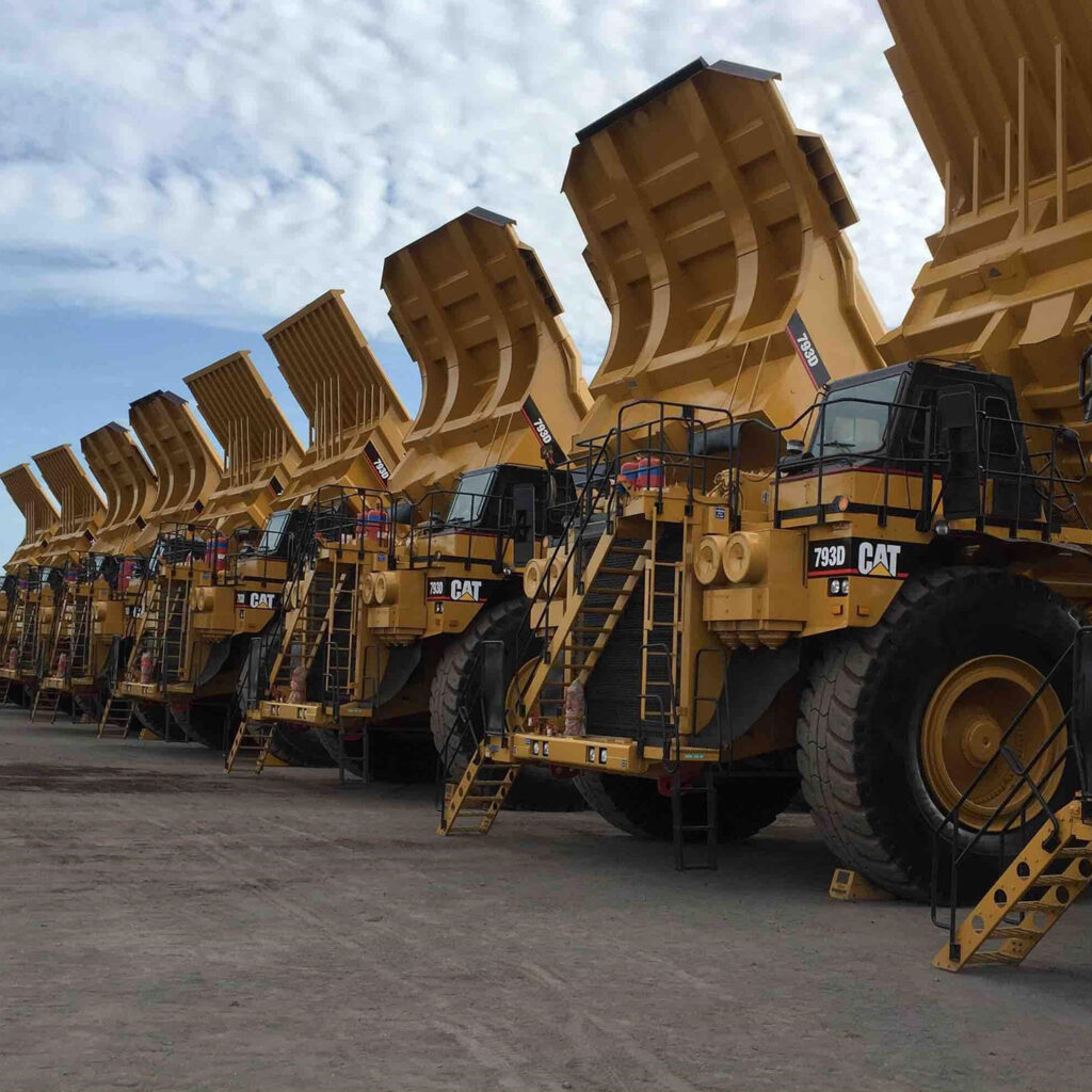 A row of mining trucks lined up parked